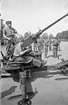 Unidentified gunners manning a Bofors 40mm. anti-aircraft gun during an inspection of anti-aircraft regiments of the Royal Canadian Artillery (R.C.A.) by General A.G.L. McNaughton and Major-General P.J. Montague, Colchester, England, 9 July 1941 July 9, 1941.