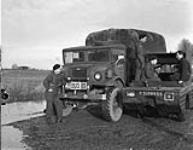 Personnel of the 17th Duke of York's Royal Canadian Hussars transferring from a "Seep" (waterized jeep) vehicle to the Chevrolet C15A truck which serves as the unit's bus, Weener, Germany, 13 February 1946 February 13, 1946.