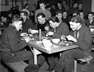 Naval ratings having dinner aboard the Canadian-manned aircraft carrier H.M.S. NABOB, Vancouver, British Columbia, Canada, January 1944 January 1944.