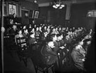 Des enfants canadiens d'origine chinoise regardent un film de l'Office national du film Dec. 1945
