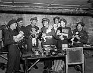 Members of the 7th Infantry Brigade Workshops Company, R.C.E.M.E., with toys repaired for Christmas;(L-R:)Cfn. R.G. Belec, Cfn G. Legault, Major G.T. Burgess, Col. C.R. Booehm, Cfn. P. Legault, Cfn. E. Blakeney & Cpl. G. Gravel 12 Dec. 1949