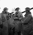 War correspondent Douglas Amaron of the Canadian Press interviewing two British members of a Bofors anti-aircraft gun crew, Grave, Netherlands, 11 February 1945 February 11, 1945