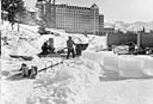 Ice being cut for research on Habbakuk, the giant floating airdrome proposed by Geoffrey Pyke, director of programs at combined operations headquarters in Britain. Research was under C.J.Mackenzie at Patricia and Jasper Lakes in Alberta c.a. 1943