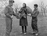 Sergeant-Major Gordon Keyes and Private R. Neary buying a chicken from an Italian woman, 29 January 1945 January 29, 1945