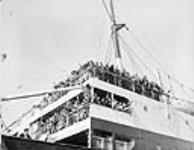War brides en route to Canada aboard S.S. Letitia waving goodbye to families and friends 2 Apr. 1946