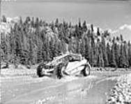 A copra earth mover working on a section of the Trans-Canada Highway, 2 miles east of Banff, in Banff National Park Aug. 1953