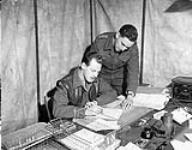 Staff officers of the 2nd Canadian Infantry Division discussing unit reinforcements, Berendrecht, Netherlands, 26 October 1944 26-Oct-44