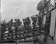 Canadian soldiers boarding a tender going out to a troopship en route to Canada, Gourock, Scotland, 21 June 1945 June 21, 1945