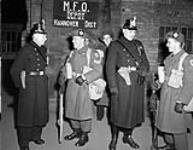German policemen welcome men of the 1st Canadian Highland Battalion on their arrival at the central station 17 Dec. 1951
