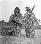 Two unidentified snipers, in "ghillie" suits, of the 1st Canadian Parachute Battalion during an inspection by King George VI, Queen Elizabeth and Princess Elizabeth, Salisbury Plain, England, 17 May 1944 May 17, 1944.