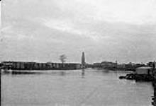 `Port Severn': looking from the water towards the docks and piles of lumber 1892
