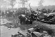 Refugees embarking in a boat on Porcupine Lake to escape from the flames of the Great Forest Fire of 1911 11 July 1911