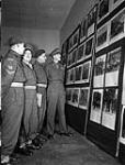 Canadian officers and non-commissioned officers awaiting repatriation, visiting the Canadian Army Film and Photo Unit's photography exhibition, Aldershot, England, 10 October 1945 10-Oct-45