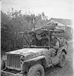 A jeep ambulance of the Royal Canadian Army Medical Corps (R.C.A.M.C.) bringing in two wounded Canadian soldiers on the Moro River front south of San Leonardo di Ortona, Italy, 10 December 1943 Deember 10, 1943.