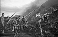 Sappers of the 3rd Field Company, Royal Canadian Engineers (R.C.E.), burning coal piles during Operation GAUNTLET, the Spitsbergen raid, Barentsburg, Spitsbergen, ca. 27 August - 2 September 1941 [ca. August 27 - September 2, 1941].