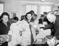 Christmas gifts are handed out to incoming refugees on Christmas Eve 24 Dec. 1959