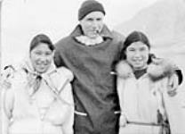 Me and my girlfriends at "Pang" [Rosie Okpik (left), unidentified priest, and Annie Maniapik (right).] ca. 1950 - 1959.