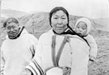 Average inuit family at "Pang" [Kanayuk (left) with Shaamuuni and unidentified baby (right).] ca. 1950 - 1959.