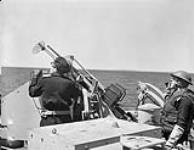 The crew of one of H.M.C.S. IROQUOIS' Oerlikon anti-aircraft guns at action stations during a training exercise off Halifax, Nova Scotia, Canada, 2 June 1944 June 2, 1944
