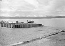 Unloading R.M.S. Nascopie's scow at dock 12 September 1945