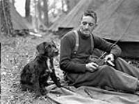 An unidentified member of the Sherbrooke Fusiliers Regiment with his unit's canine mascot, England, 20 April 1944 April 20, 1944