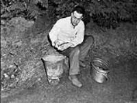 Trooper R. Cochrane of the Essex Regiment peeling potatoes, England, 27 January 1944 January 27, 1944