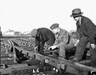 Lieutenant F.S. Hutton, a student at the Khaki University of Canada, observing Southern Railway track removal operations, Mitcham, England, 15 January 1946 January 15, 1946
