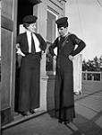 Unidentified signalers of the Women's Royal Canadian Naval Service (W.R.C.N.S.) and Royal Canadian Navy (R.C.N.) comparing bellbottom trousers, Esquimalt, British Columbia, Canada, 22 February 1944 February 22, 1944.