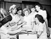 Ex-servicewomen learning manicure techniques during a retraining course on beauty parlour operation at the Robertson Hairdressing School Apr. 1945