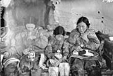 Inuit family inside an igloo 1948-1953.