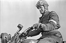 An unidentified despatch rider of the Royal Canadian Corps of Signals (R.C.C.S.) riding a Norton motorcycle during a 4th Canadian Armoured Division training exercise, Aldershot, England, 11 January 1943 January 11, 1943