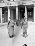 Major-General Stephan, the commander of Battle Group Stephan, is accompanied by Captain P. Fafard of the 2nd Canadian Infantry Division into a surrender conference, Oldenburg, Germany, 7 May 1945 May 7, 1945