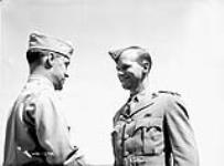 Colonel G.P. Howell (left), Commandant, U.S. Army Parachute School, presenting American "Jump Wings" to Captain C.F. Hyndman, Medical Officer, 1st Canadian Parachute Battalion, Fort Benning, Georgia, United States, 12 September 1942 September 12, 1942