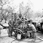 Personnel of the 1st Armoured Brigade Workshop, Royal Canadian Electrical and Mechanical Engineers (R.C.E.M.E.) working on the engine of a Sherman tank of the 5th Canadian Armoured Division, Italy, 13 October 1943 October 13, 1943.