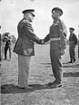 Sergeant G.A. Rainville, former Canadian member of the First Special Service Force, receiving the Silver Star from Brigadier-General E.F. Koenig, Commander of U.S. Forces in the United Kingdom, Canadian Repatriation Unit, England, 24 April 1945 April 24, 1945.