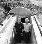 Two Japanese soldiers emerging from an air-raid shelter, Atsugi, Japan, 1945 1945.