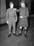 Corporal Alfred Daoust (left) of Les Fusiliers Mont-Royal and Sergeant E.L. Dixon of The Essex Scottish Regiment, both of whom received the Military Medal during an investiture at Buckingham Palace, London, England, 27 October 1942 October 27, 1942.