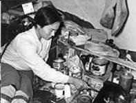 Inside a tent - woman with can on the ground - cudlik n.d.