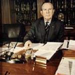 Honourable L.B. Pearson sitting at is desk ca. 1948 - 1968