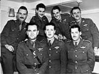 Seven repatriated parachute-qualified Canadian officers, who took part in Special Operations Executive (S.O.E.) missions prior to and following D-Day, on a troopship arriving at Halifax, Nova Scotia December 16, 1944.