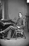 Mr. Low sitting at a desk October, 1881.