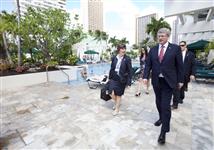 [Prime Minister Stephen Harper walks past the pool on his way to a meeting at the APEC Summit in Honolulu, Hawaii] 12 November 2011