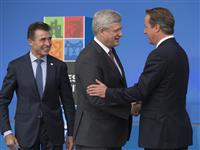 [Prime Minister Stephen Harper is greeted by David Cameron, Prime Minister of the United Kingdom, Anders Fogh Rasmussen, NATO Secretary General, upon his arrival at Celtic Manor for the North Atlantic Treaty Organization (NATO) Summit in Newport, Wales] 4 September 2014