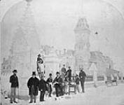 Group of men photographed in front of the main gate, Parliament Hill, with East Block in background [graphic material] ca. 1873-1874