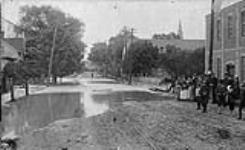 [Street partly flooded] c 1880-1930