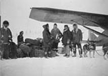 Mail being transferred from plane to dog team at Aklavik [N.W.T.] n.d.
