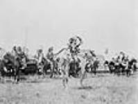 Portrait of Chief Joe Healy and warriors on horseback 1907