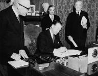 His Excellency Viscout Alexander of Tunis, Governor General of Canada (seated) signs Bill related to terms of union with Newfoundland Feb. 1949