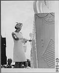 Her Majesty Queen Elizabeth cuts the cake, July 1st, at the Centennial Party on Parliament Hill 1 July 1967.