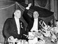 Hon. Ernest Lapointe introducing Rt. Hon. W.L. Mackenzie King during a ceremony celebrating Mr. King's twentieth anniversary as Leader of the Liberal Party 8 Aug. 1939